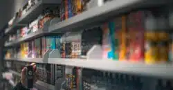 woman in black shirt standing in front of store shelf